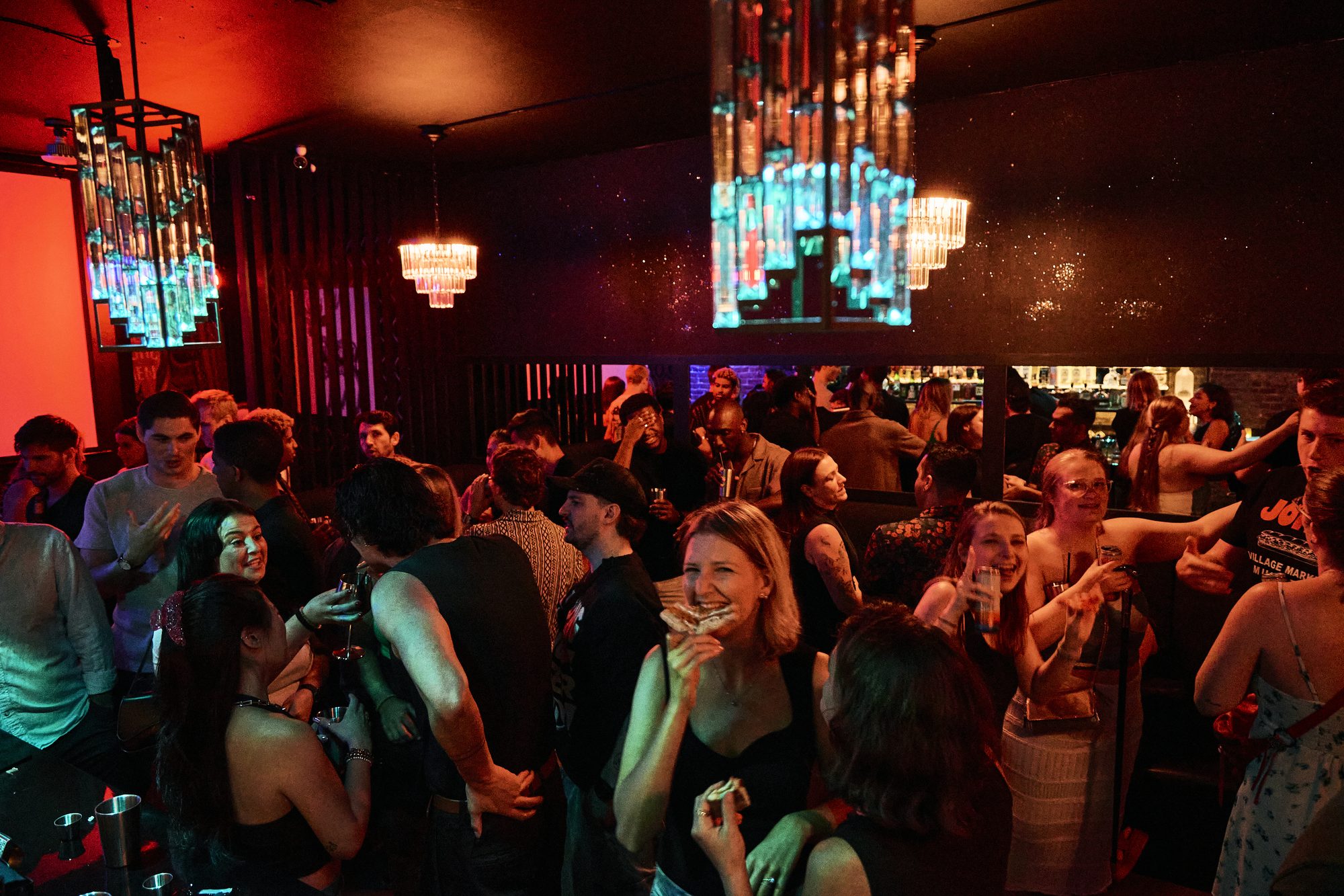 The B Lounge under warm red light during a party