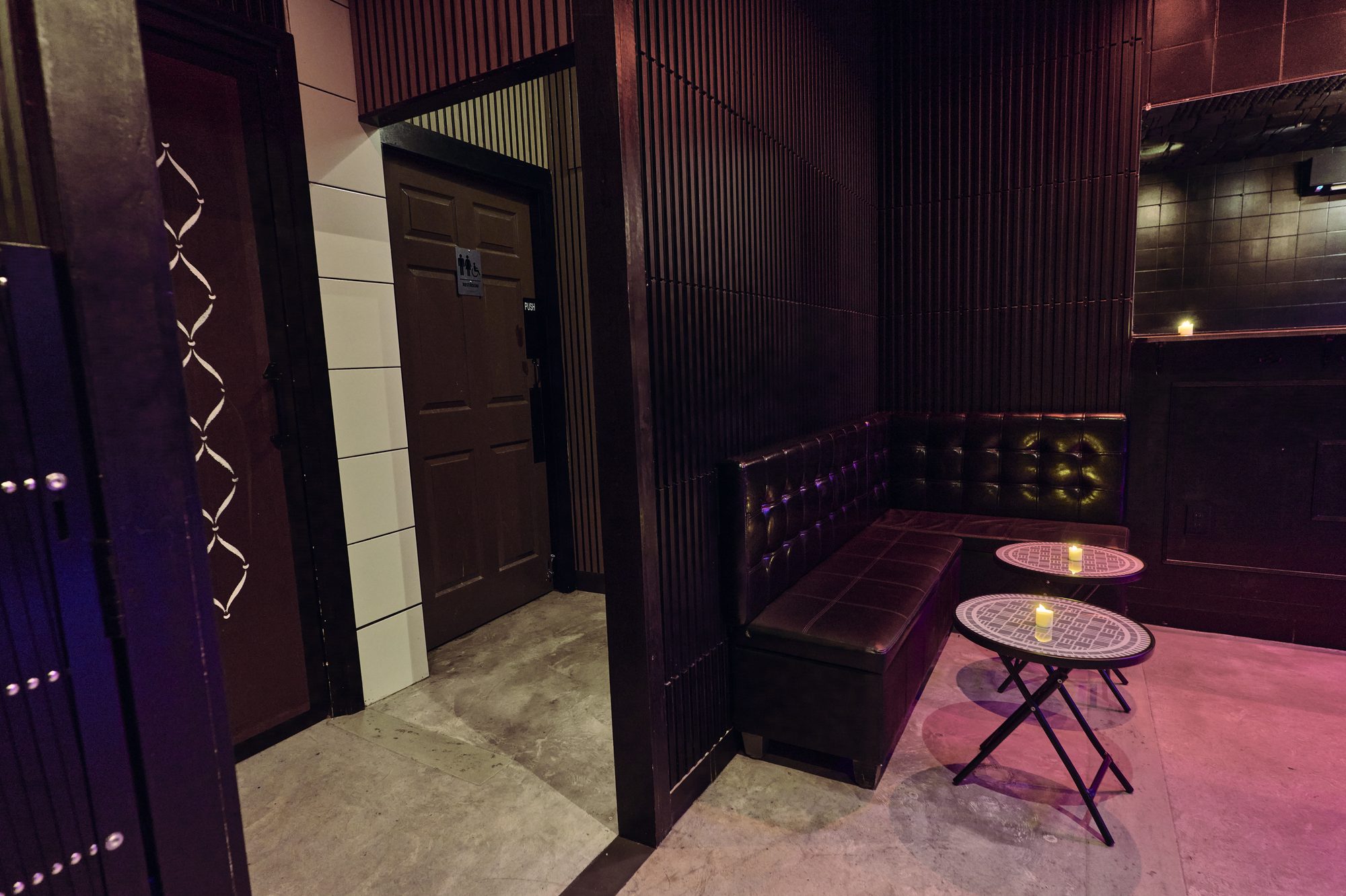 A tufted corner booth in the Back Room