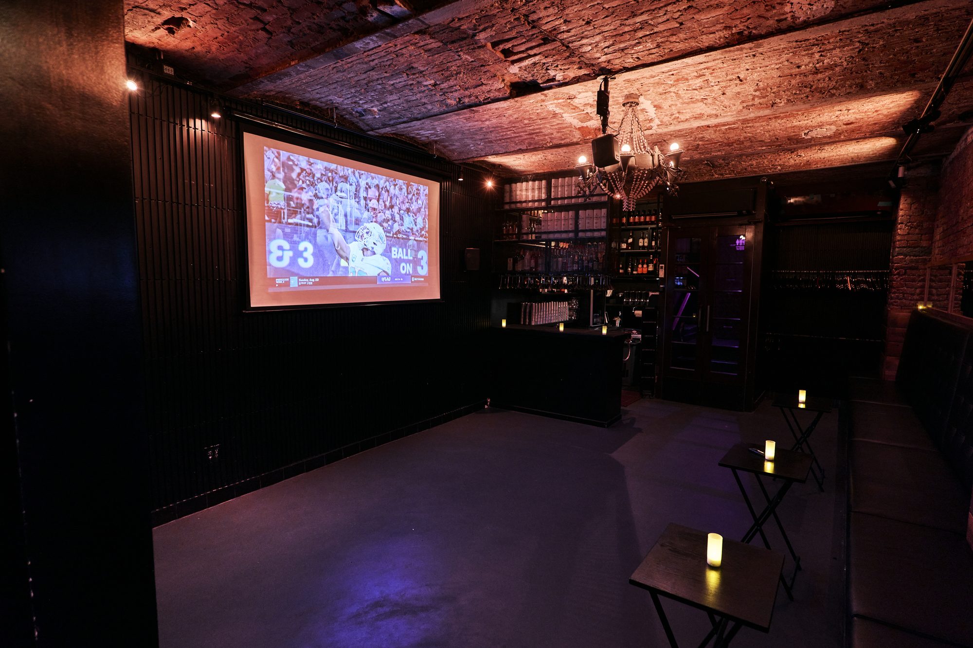 Game on the Whiskey Cellar projector, bar in the background